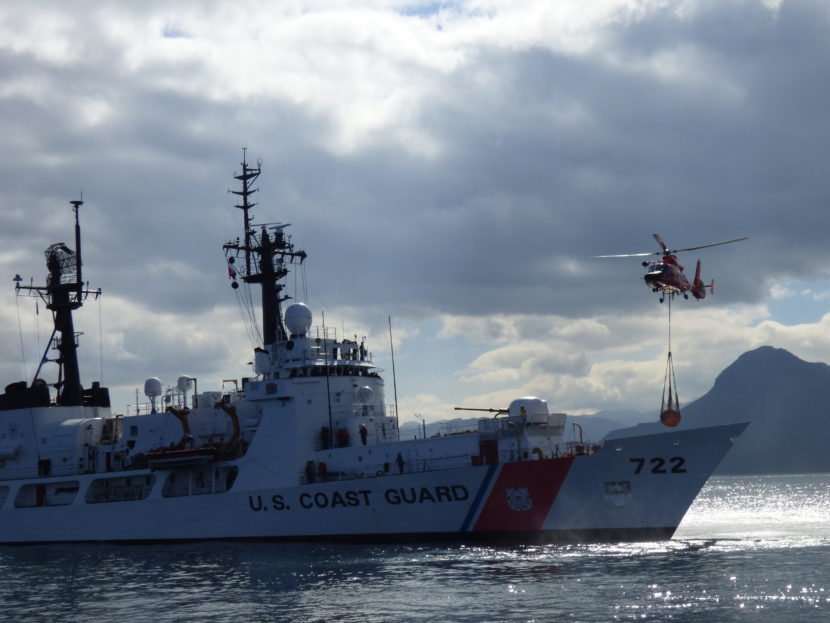 A helicopter practices dropping an Emergency Towing System on the Coast Guard cutter Morgenthau. (Zoe Sobel/KUCB)