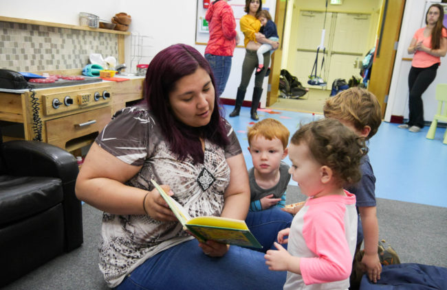 Gehring Nursery School worker Allison Cadiente-Laiti-Blattner reads to a group of children. (Photo by Lakeidra Chavis/ KTOO)