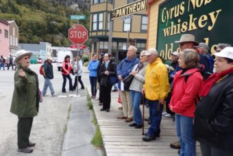 Park ranger Charlotte Henson leads a group of visitors on a walking tour of Skagway focused on the story of Company L. (Photo by Emily Files/KHNS)