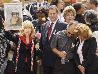 Sally Regenhard (left) holds a photo of her son, Christian, during a commemoration ceremony for Sept. 11 victims in New York City in 2008. Julie Jacobson/AP