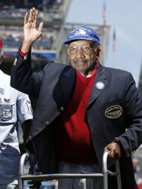 In June 2013, Tuskegee Airman Dabney Montgomery waves to the crowd as he is introduced before the start of a baseball game in New York. (Photo by Kathy Willens/Associated Press)