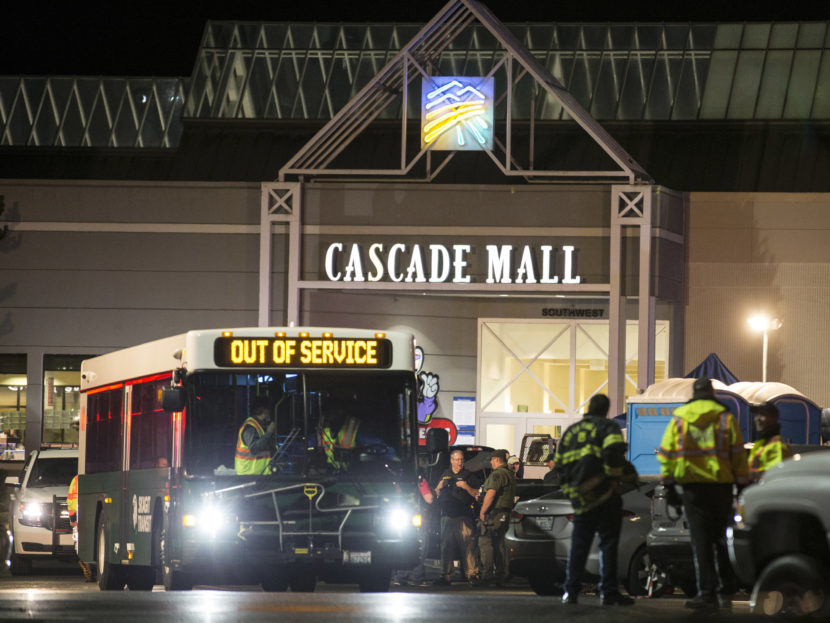 Emergency personnel stand in front of an entrance to the Cascade Mall at the scene of a shooting where five people were killed on Friday in Burlington, Wash. Stephen Brashear/AP