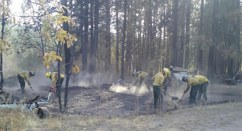 Firefighters mop up remaining fire and heat near residences threatened by the Cayuse Mountain Fire. (INCIWEB)