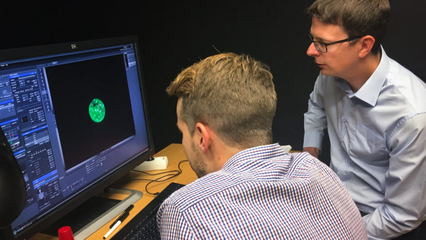 Fredrik Lanner (right) of the Karolinska Institute in Stockholm and his student Alvaro Plaza Reyes examine a magnified image of an human embryo that they used to attempt to create genetically modified healthy human embryos. (Photo by Rob Stein/NPR)