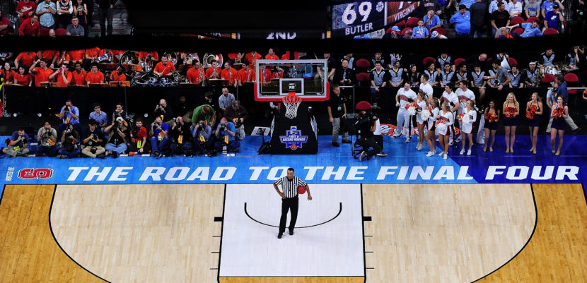 An official and others wait for play to resume during an NCAA Men's Basketball Tournament second-round game between the Butler Bulldogs and the Virginia Cavaliers in March in Raleigh, N.C. This coming spring the Road to the Final Four won't go through North Carolina, as the NCAA has decided to move three games out of Greensboro. (Photo by Grant Halverson/Getty Images)