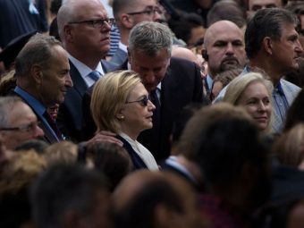 New York City Mayor Bill de Blasio speaks to Democratic presidential nominee Hillary Clinton during a memorial service at the National September 11 Memorial and Museum. (Photo by Bremdam Smialowski /AFP/Getty Images)