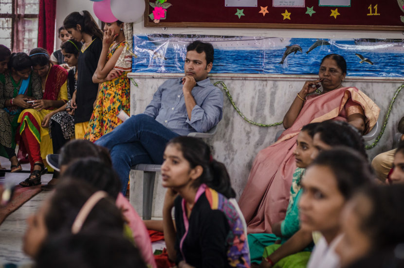 Mahendra Sharma watches a performance by students at the Veerni Institute. He says that many of them now get higher marks than he did when he was in high school. "It gives me a complex sometimes," he says laughing. Poulomi Basu for NPR