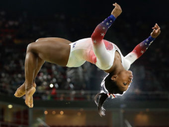Simone Biles flies through the air while performing on the balance beam at the Olympics in Rio de Janeiro. (Photo by Dmitri Lovetsky/Associated Press)