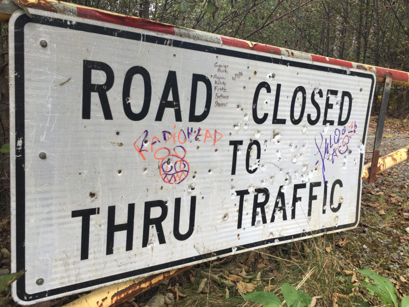 A sign at the end of Glacier Highway, near where the Juneau Access Road extension would be built. Gov. Walker is weighing whether to back the project.Oct. 4, 2016. (Photo by Andrew Kitchenman/KTOO)