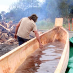 Tommy Joseph feels the warm water after the batch of lava rocks are taken out. (Photo by Emily Russell/KCAW )