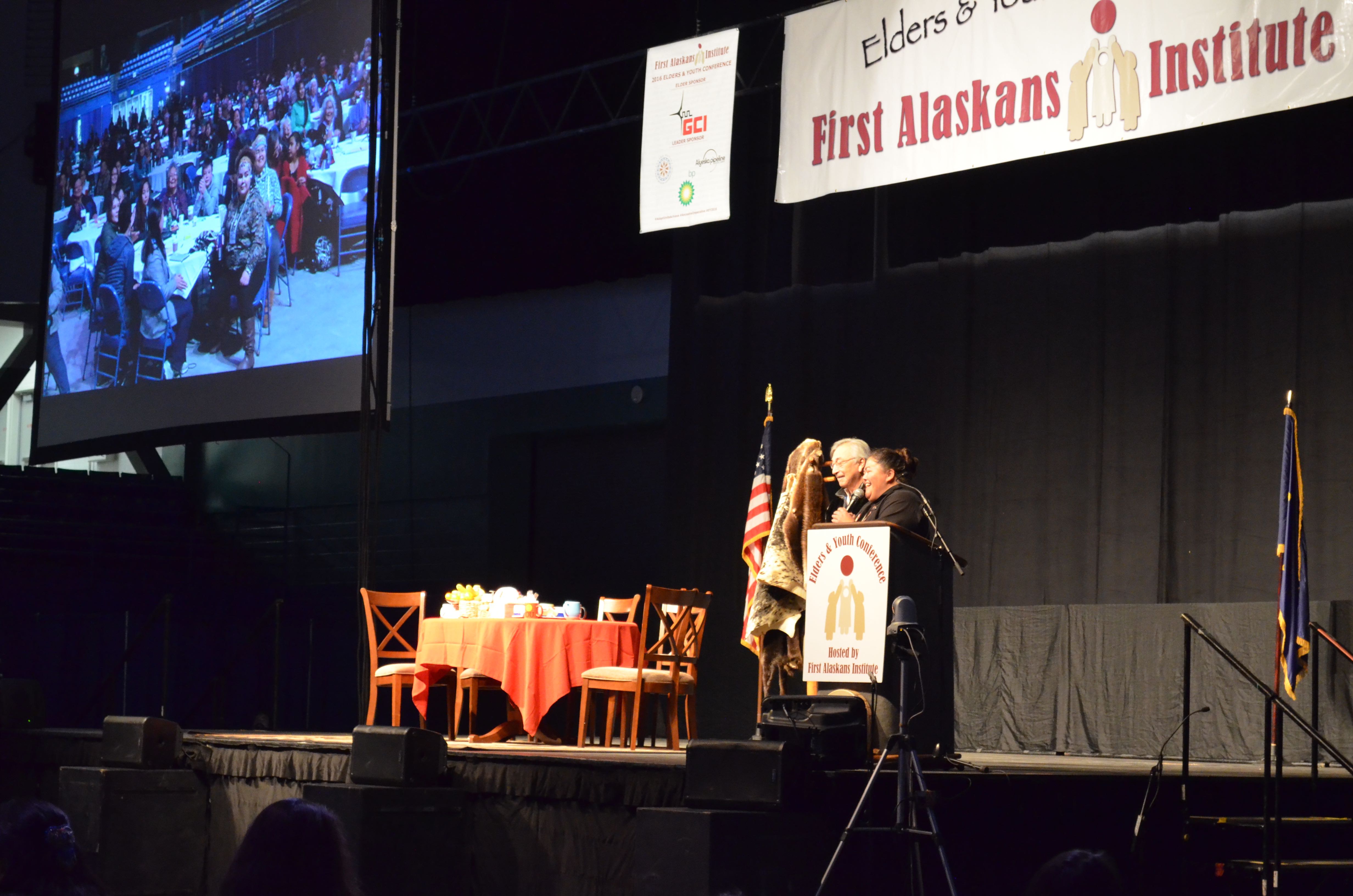 Liz Medicine Crow, president and CEO of First Alaskans Institute, and board chair Willie Hensley give opening remarks at the 33rd annual Elders and Youth conference in Fairbanks. (Photo by Jennifer Canfield)