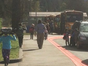 Students board buses outside of Glacier Valley Elementary School.