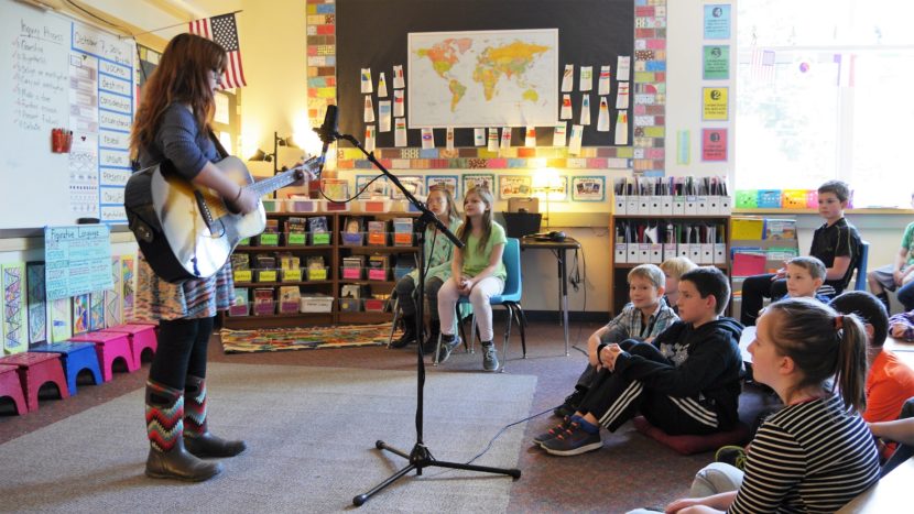 Filori's mini concerts have become a Friday routine after lunch recess. One student said it's a nice way to transition back into the classroom. (Photo by Scott Burton/KTOO)