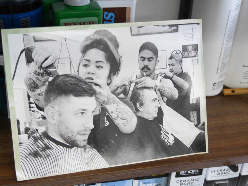 A photo of the Carrillo family sits on a shelf inside Gerry's Barbershop. From left to right: Eva, Gerry Jr., and Gerry Sr. 