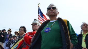 Before the canoes can come ashore, they must get permission from the Auke Kwan Tlingits of Juneau. Fran Houston of the Auke Kwan was joined by Paul Marks of the Douglas Indian Association to carry out the tradition. (Photo by Emily Kwong/KCAW)
