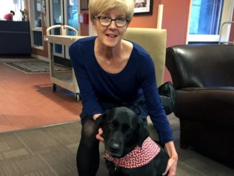 Karen Lorne, diagnosed with Lou Gehrig's disease in July, volunteers weekly with her certified therapy dog, Bailey, at the Ronald McDonald House in Chapel Hill, N.C. (Photo courtesy of Karen Lorne)