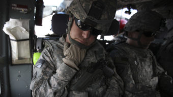 The Pentagon is seeking millions of dollars from nearly 10,000 current or former soldiers in the California National Guard, saying they didn't deserve reenlistment bonuses. Here, soldiers from the state's Guard force are seen in 2010, resting during transport in northeastern Afghanistan.