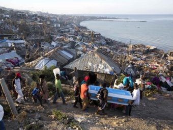 Residents carry a coffin containing the remains of a pregnant woman killed by Hurricane Matthew, in Jeremie, Haiti. People across southwest Haiti are salvaging what they can from wreckage the Category 4 storm caused. Dieu Nalio Chery/AP
