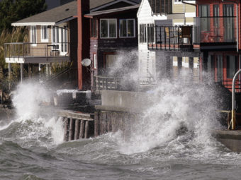 Waves batter a seawall on Friday in Seattle. The remnants of a typhoon brought rain and wind to the Pacific Northwest on Friday and Saturday. Elaine Thompson/AP