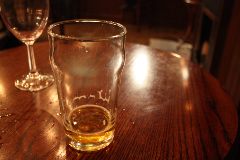 empty pint glass at bar