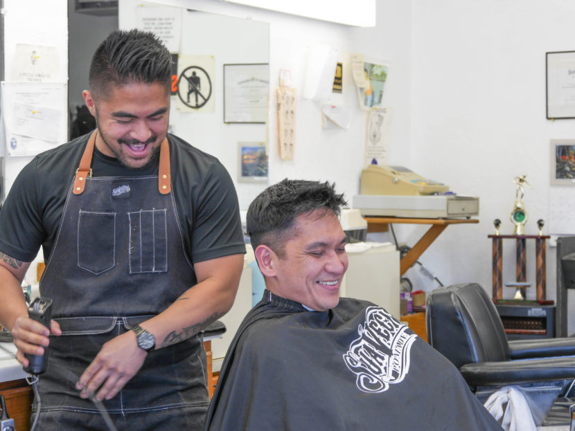 Gerry Carrillo Jr. cuts David Mende's hair. Gerry is the newest family member to work at Gerry's Barbershop. 