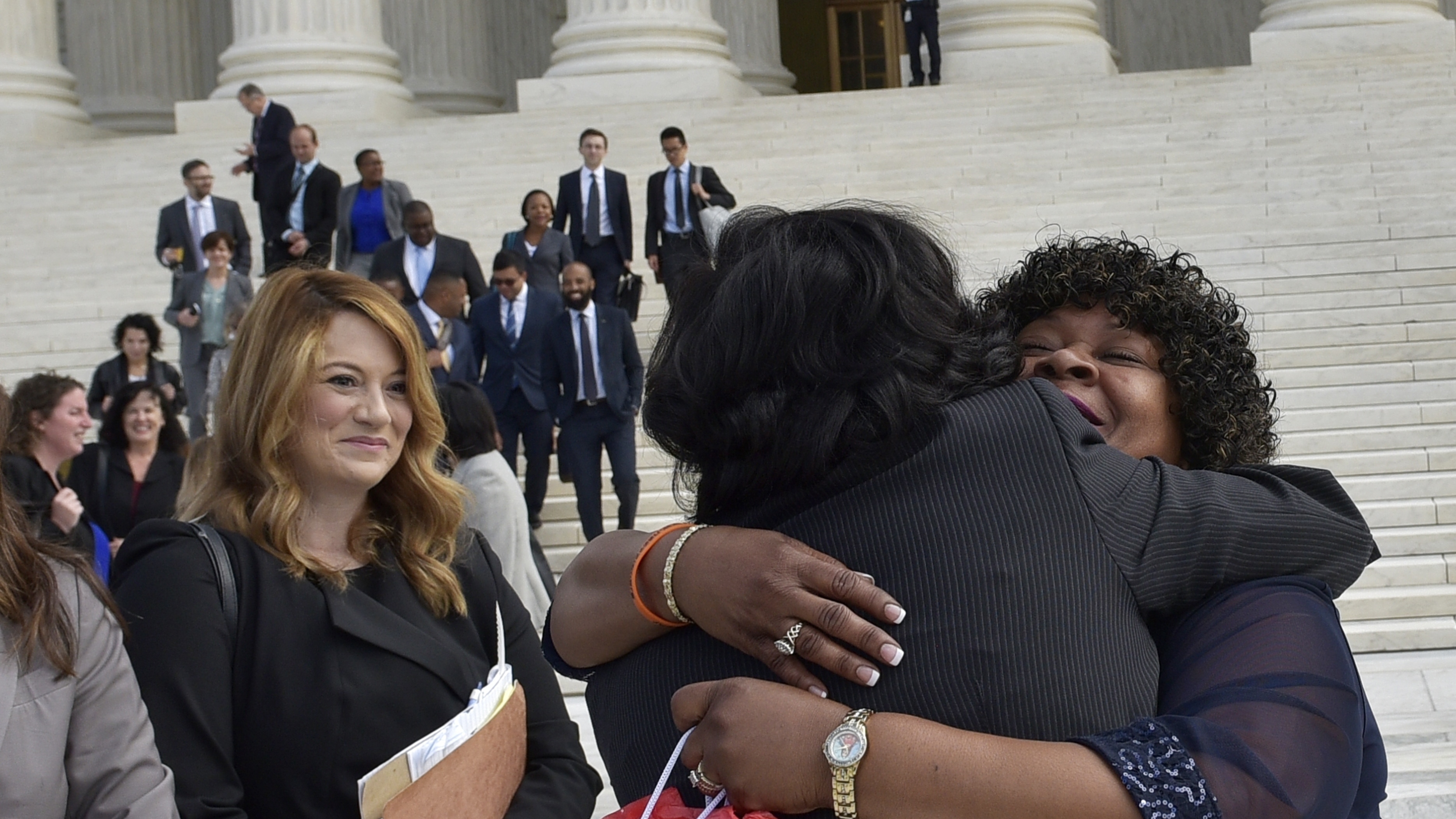 Christina Swarns, center, the lead counsel for Duane Buck, is embraced by Buck's stepsister Phyllis Taylor, right, outside of the U.S. Supreme Court on Oct. 5 in Washington, D.C. (Photo by Mandel Ngan/AFP/Getty Images)