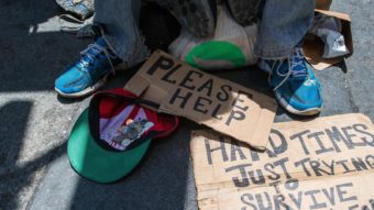 Andrew Loy begs along a sidewalk in San Francisco, Calif. on June 28, 2016. (Photo by Josh Edelson/AFP/Getty Images)