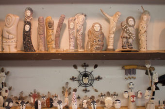 Walrus ivory carvings and masks, like these on display at Maruskiya’s in Nome, may be threatened by other states’ bans on the sale, purchase, and trade of various types of ivory. (Photo by Emily Russell/KNOM)