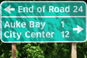 A sign near Juneau’s Auke Bay Ferry Terminal points to the end of Glacier Highway. (Photo by Ed Schoenfeld/CoastAlaska News)