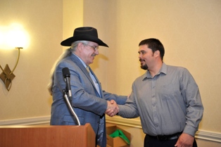 Hydaburg Mayor Tony Christianson accepts an award from the U.S. Forest Service in May, 2013.