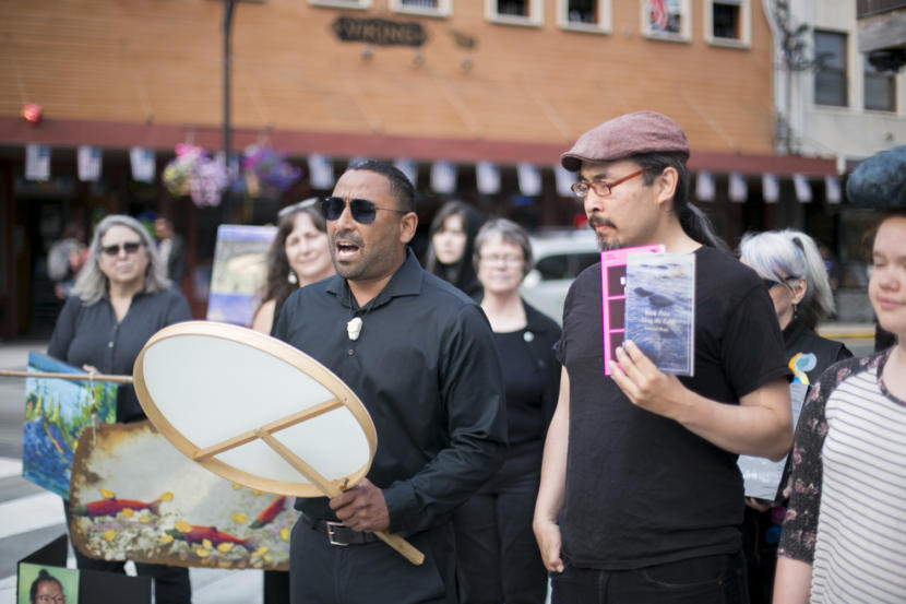 Juneau Arts and Humanities Council Education Director Stephen Qacung Blanchett of the band Pamyua shares a prayer song next to Ishmael Hope at the peaceful demonstration protesting budget cuts to the Alaska State Council on the Arts. Photo by Annie Bartholomew)