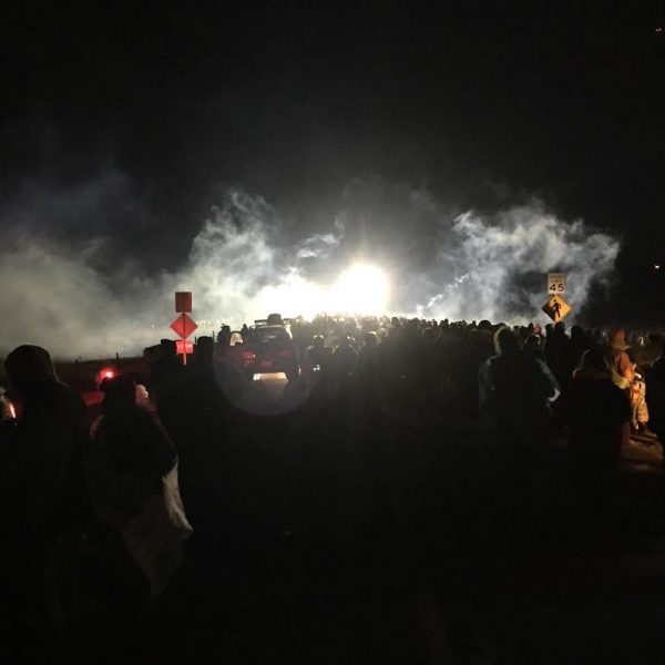 Demonstrators who call themselves water protectors faced law enforcement officers who fired rubber bullets and water cannons in below freezing temperatures near Cannon Ball, ND on the evening of Sunday, Nov. 20. (Photo courtesy of Tracy Peterson)