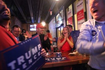 George LaMoureaux, statewide volunteer coordinator for the Trump campaign, celebrated with his daughter, Ashley LaMoureaux, at Flattop Pizza in downtown Anchorage. (Photo by Rachel Waldholz/Alaska’s Energy Desk)