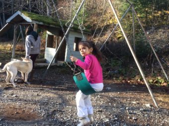Camille Chase swings on the Tenakee Springs playground in November 2016. (Photo by Quinton Chandler/KTOO)