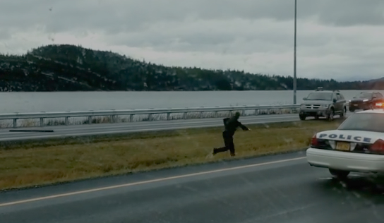 A Juneau Police Department officer in the median of Egan Drive dodges the vehicle barreling at him in this still from a video posted to Facebook by Richard Koddi Moe). The driver swerved at the officer, who was attempting to use a spike strip.