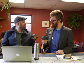 Justin Parish speaks with his campaign manager at a coffee shop in the Mendenhall Valley. (Photo by Lakeidra Chavis/ KTOO)