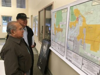Saxman residents look at maps before the Alaska Mental Health Trust meeting at the Saxman Community Center. (Photo by Leila Kheiry/KRBD)