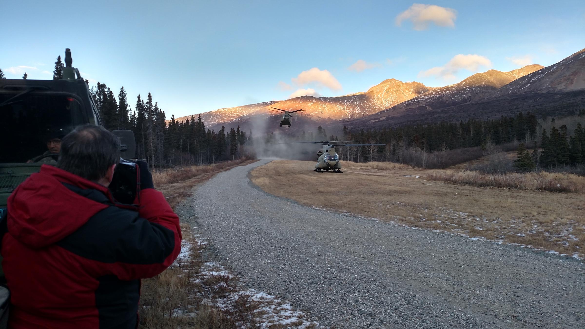 A second Chinook helicopter carrying U.S. and Canadian general/admiral-ranking officers and their staffs kicks up dust Tuesday upon landing at Black Rapids Training Site after a flight from Eielson Air Force Base. (Photo by Tim Ellis/KUAC)