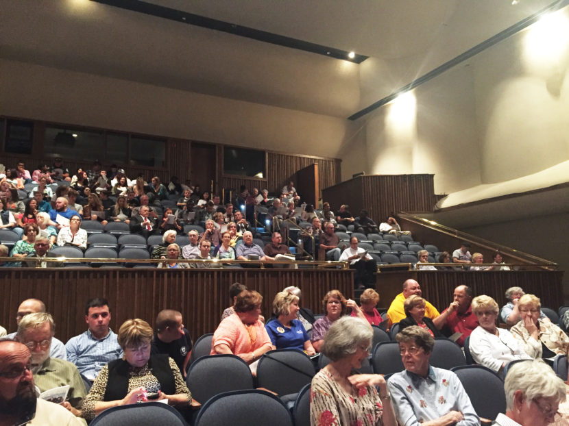 A few hundred people gather in an auditorium at Hutchinson Community College in Hutchinson, Kan., to watch the state Supreme Court hear oral arguments. Ashley Cleek for NPR