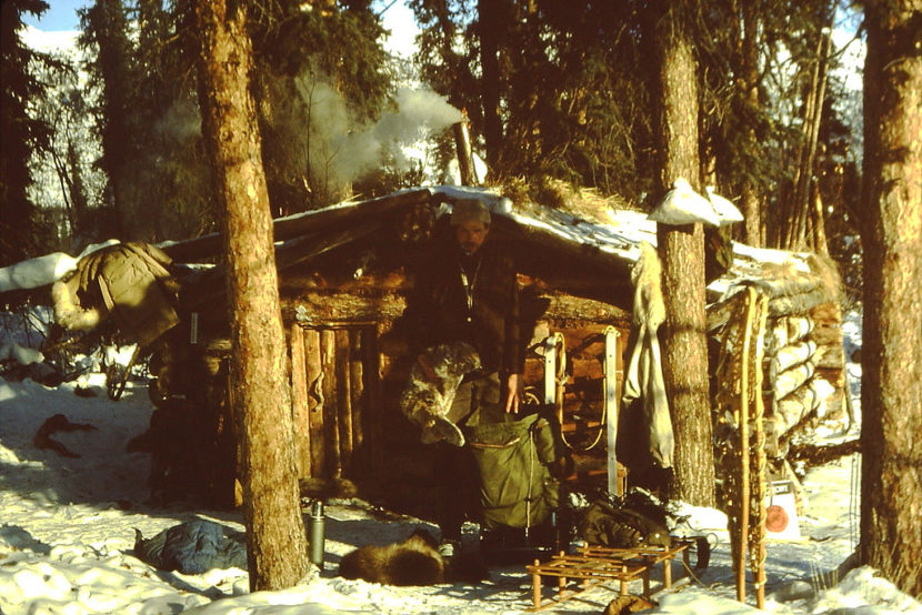 A trapper stands in front of his cabin in the Brooks Range, c. 1980. (Creative commons photo by Karl Friedrich Herhold)