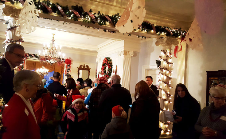 The entry way was crowded with incoming and outgoing visitors to the annual holiday open house at the Alaska Governor Mansion on Tuesdasy, Dec. 6, 2016 in Juneau. (Photo by Tripp J Crouse/KTOO)