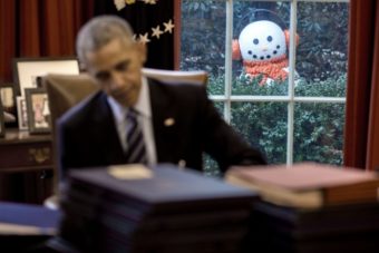 A snowman peeks into the Oval Office as President Barack Obama signs end-of-the-year bills, Dec. 16, 2016. Staff moved four snowmen that were decorating the Rose Garden just outside several Oval Office windows to greet the President when he arrived in the office.