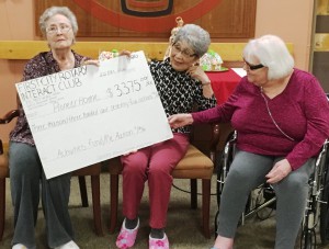 Pioneers Home residents with the big check, representing the proceeds of this year’s Rotary Interact pie sale. (Photo by Leila Kheiry)