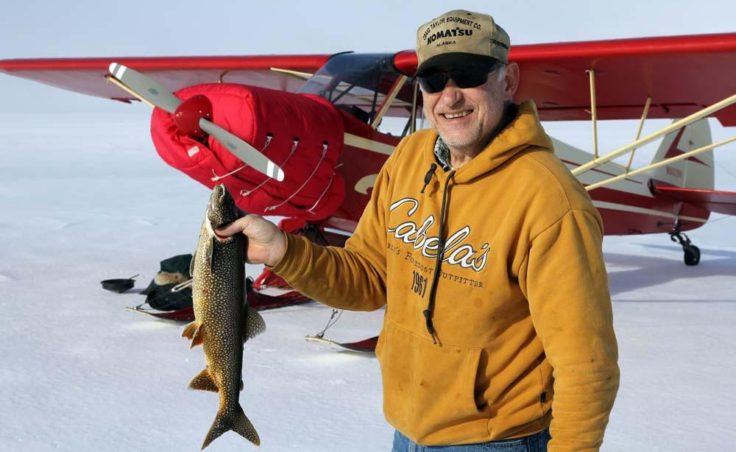 Mark Matters, his fish and his plane. (Photo by Dave Cannon)