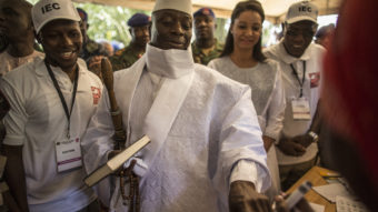 Gambian president Yahya Jammeh (center) has his finger inked before casting his marble in a polling station in a presidential poll, in Banjul on Dec. 1, 2016. Marco Longari/AFP/Getty Images