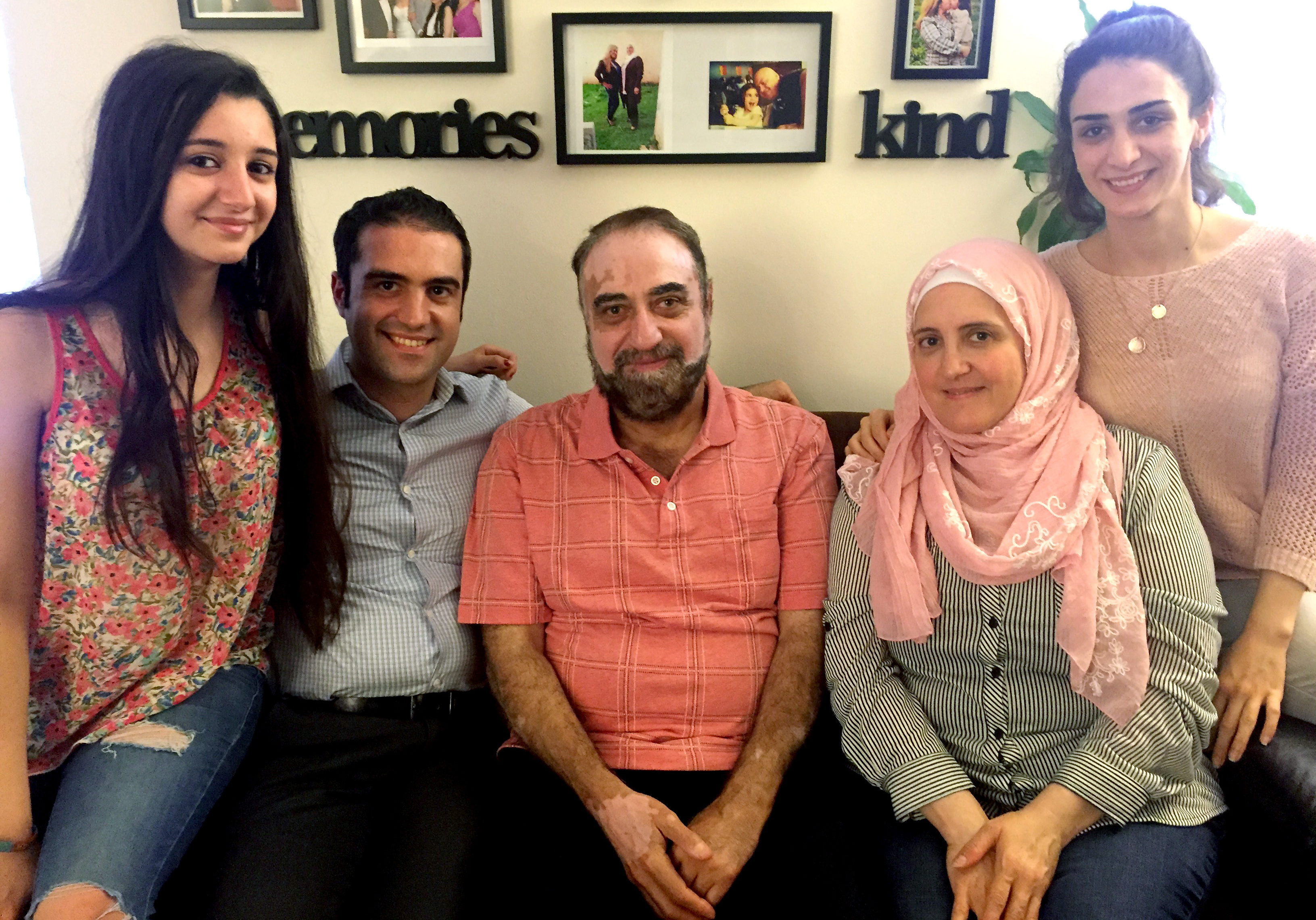 Almothana Alhamoud (second from left) with his family in Chicago. From left to right are his sister, Fatina; their father, Abdel Bari; their mother, Alia; and his other sister, Rowan. Alhamoud earned a computer engineering degree in Syria, but when he came to the U.S., he initially worked as a cashier. The group Upwardly Global helped him find a job in IT. (Photo by Deb Amos/NPR)