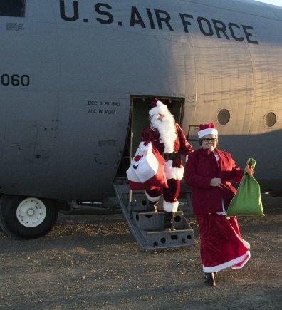 Santa Claus and Mrs. Claus deliver gifts to Togiak in 2016 as part of Alaska’s 60th Operation Santa Claus. (Photo by Alaska Army National Guard)