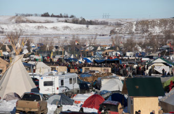 On Sunday, protesters gather at their camp as news breaks that the Army Corps of Engineers will not approve an easement for the Dakota Access Pipeline. (Photo by Cassi Alexandra for NPR)