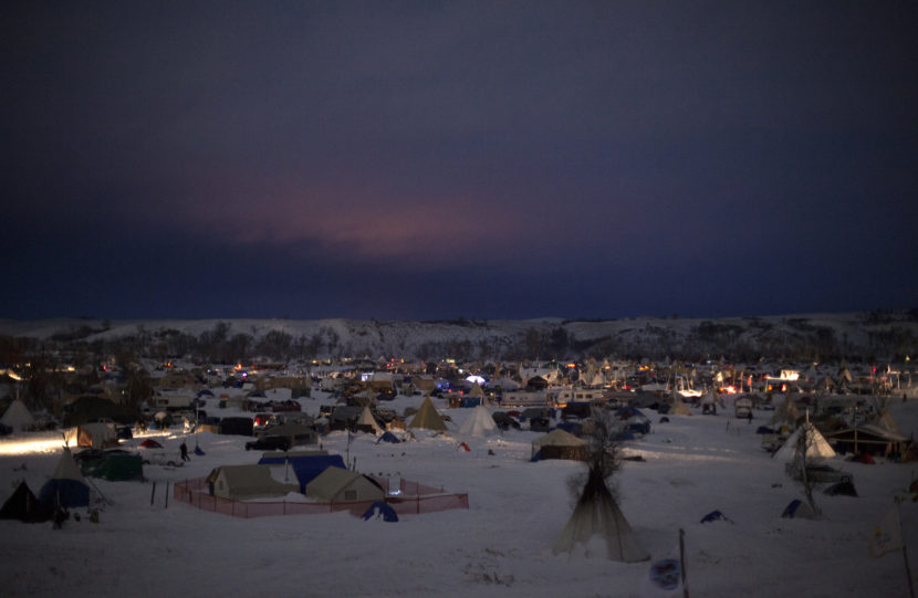 Though emergency evacuation orders have been issued by both the state of North Dakota and the Army Corps of Engineers, the three camps along the Cannonball River, now covered in snow, show no sign of packing up. Celia Talbot Tobin