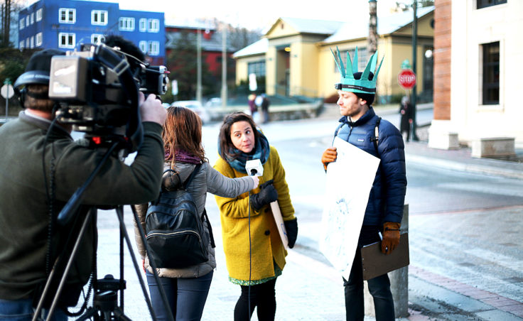 KTVA news reporter Liz Raines interviews protest organizers Jill Weitz and Dan Kirkwood in front of the Alaska State Capitol Building on Fourth Street in downtown Juneau on Monday, Jan. 30, 2017. The protest was intended to be a peaceful gathering in support of refugees and immigrants in the wake of President Donald Trump's executive orders heavily restricting immigration. (Photo by Tripp J Crouse/KTOO)